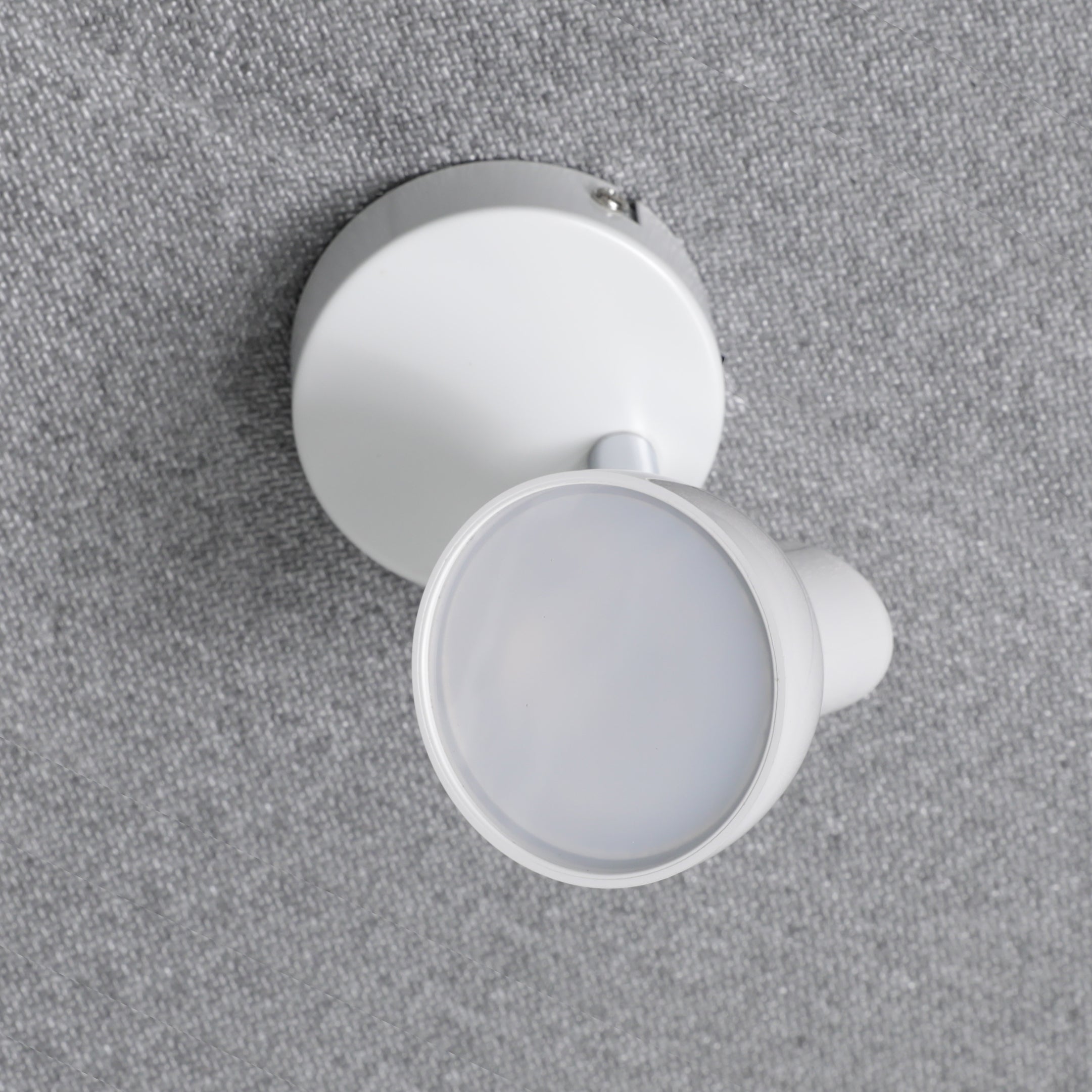 White light fixture on a gray textured background
