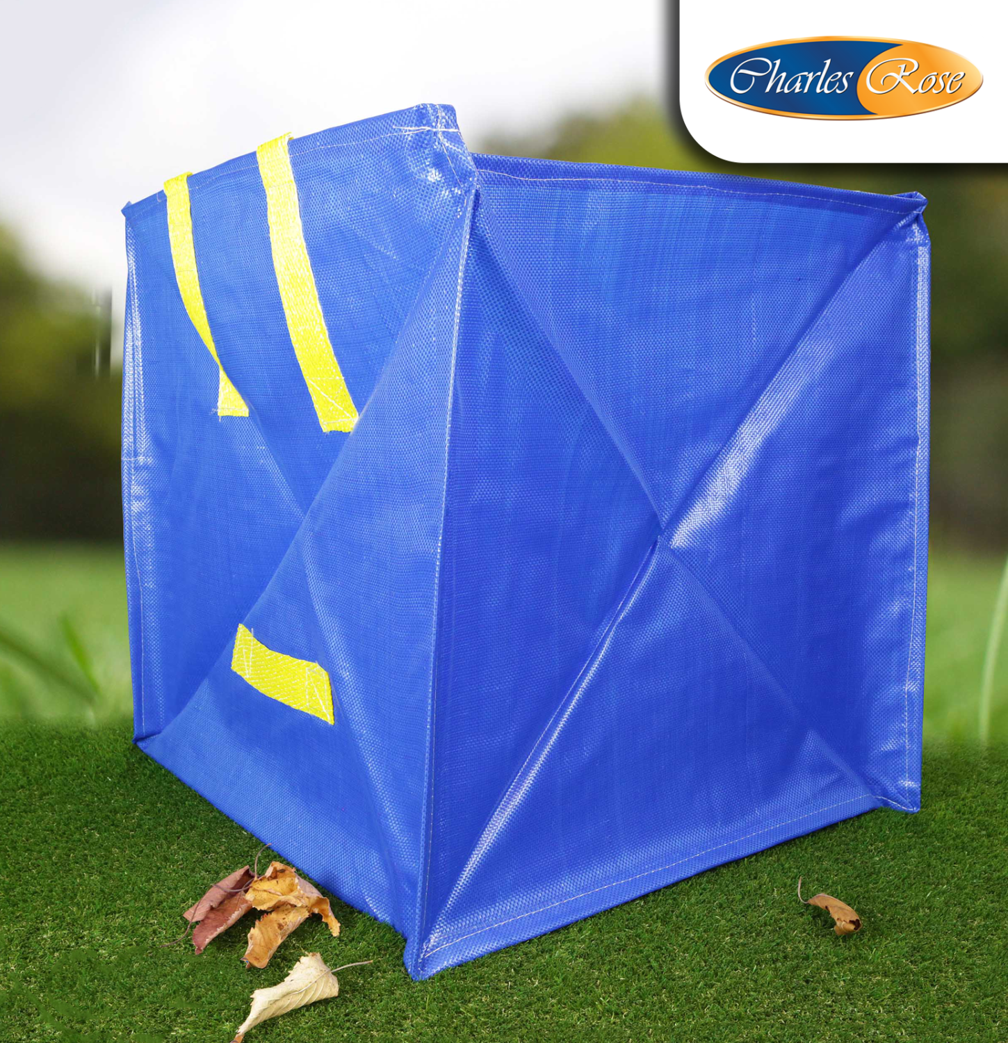 Blue tarp with yellow straps on grass, Charles Rose logo visible